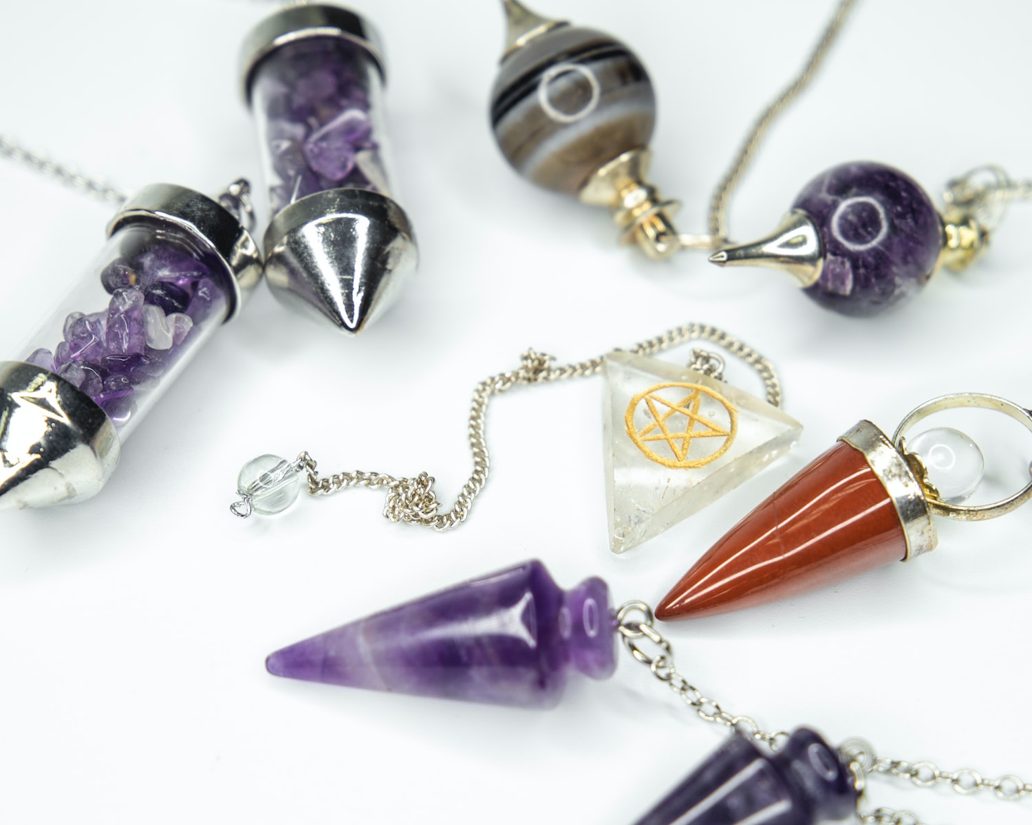 Photo by petr sidorov gold and silver necklace and purple stone pendant