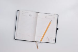 Photo by JESHOOTS.COM pencil on opened notebook